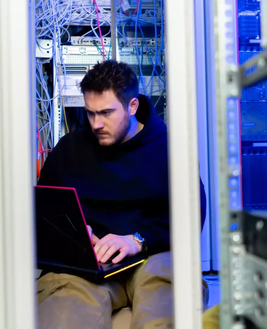 focused-hacker-in-data-center-hacking-software-sys-2024-12-02-11-50-19-utc